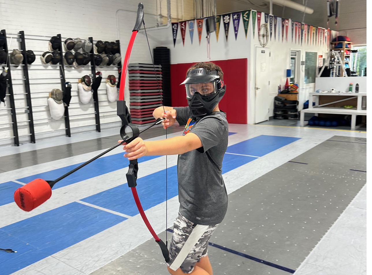 Kid with archery tag bow at Nova party