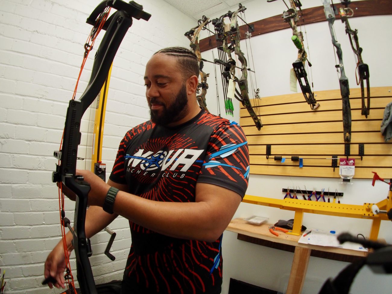 Nova&rsquo;s ATA Certified Bow Tech setting up a compound bow on the press